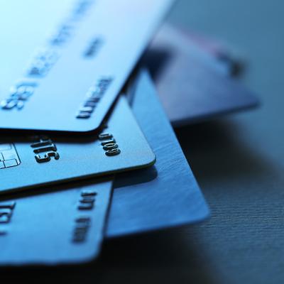 A stack of credit cards in dim light.