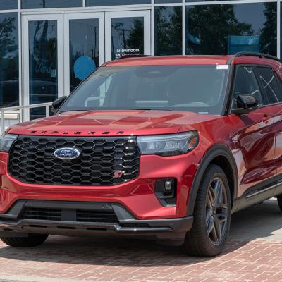 A red 2025 Ford Explorer ST AWD SUV displayed at a dealership.