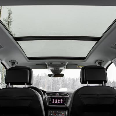 A backseat view of a panoramic roof of a car.