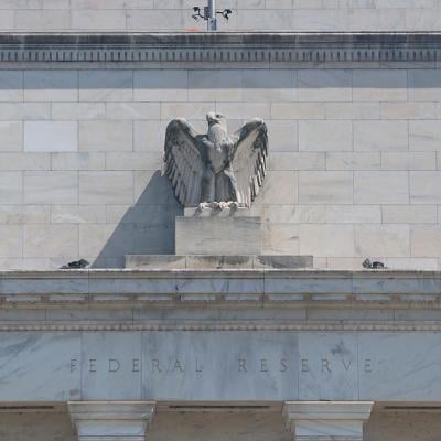 The Federal Reserve building with a figurine of the eagle above the doorway visible as it goes under construction on July 17, 2025 in Washington, DC. 
