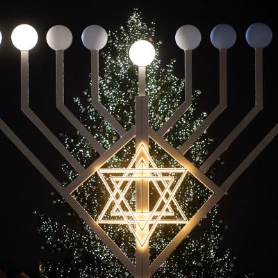 Bulbs symbolizing candles have lit on the 30 foot-tall Hannukah menorah by the Jewish education centre 'Chabad Lubawitsch' in front of a Christmas tree at the Brandenburg Gate in Berlin, Germany.
