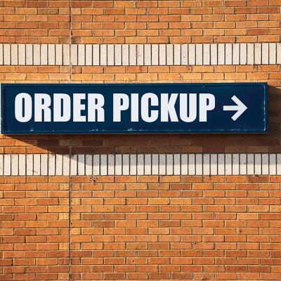 'Order pickup' sign pointing to the left at a store.