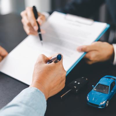 A customer signs a car purchase contract.