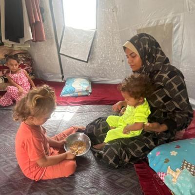 Recently widowed single mother, Noura Abu Dan, with her small children in a refugee camp on Sheikh Mohammed Ahmed.