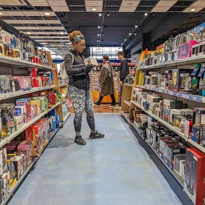  A young adult browsing in a toy and hobby shop aisle.