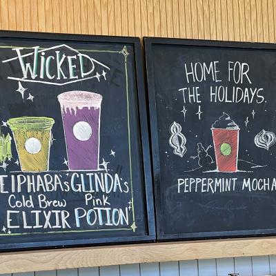 A chalkboard menu featuring Wicked x Starbucks' collaboration drinks.