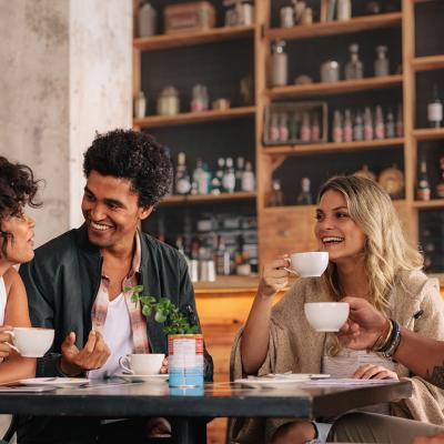 A group of friends having coffee together in a cafe.
