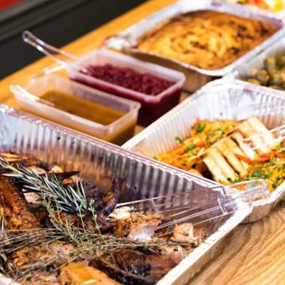 Thanksgiving dishes in catering dishes prepared on the table for serving.