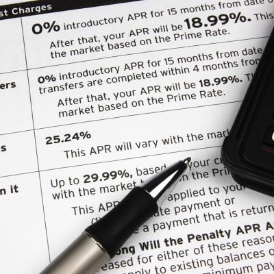 A pen and calculator on top of a credit terms report.