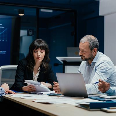 A group of business executives brainstorming in a boardroom.
