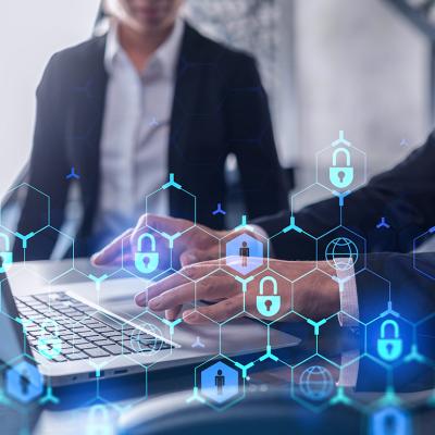 Two businesspeople in formal wear working on a project, with cyber security technology graphics illustrated.