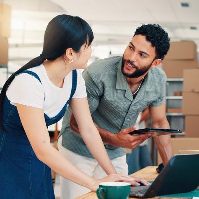 Startup business owners in their warehouse planning shipping and deliveries.