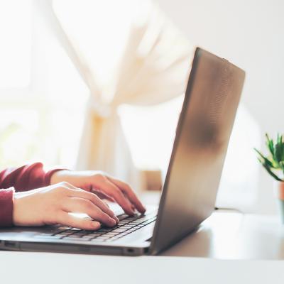 Person typing on a laptop.