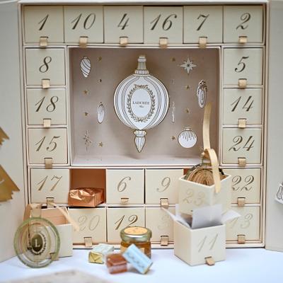 Ladurée gold Advent calendar displayed at their shop.
