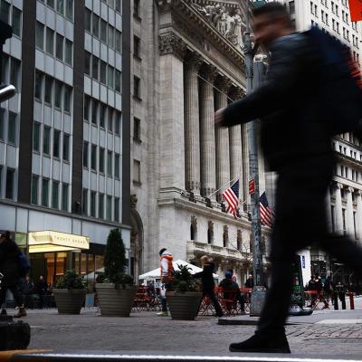 A blurred person in black clothing in the foreground walks past the New York Stock Exchange (NYSE) on November 20, 2025 in New York City. Stocks surged over 500 points after Nvidia on Wednesday reported fiscal third-quarter earnings that beat expectations.