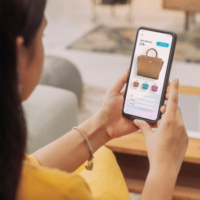 A woman browsing a shopping page on her smartphone.
