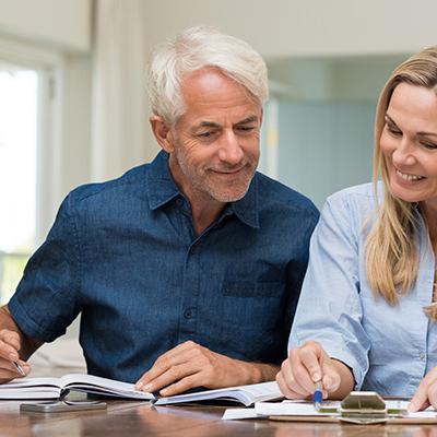 A man and a woman looking at financial documents.