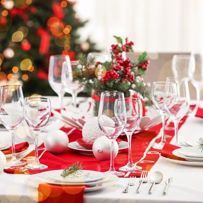 A beautiful Christmas dinner table setting with red and white motifs.