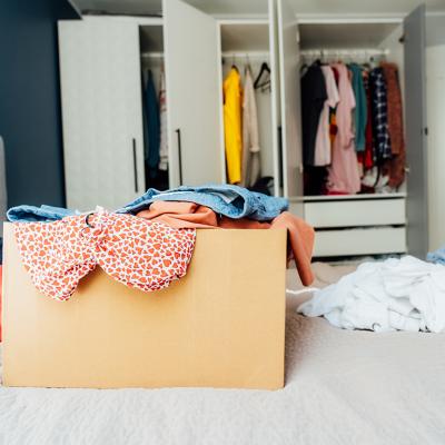 A box full of selected clothes from closet cleanup.