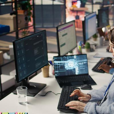 A female customer service worker using AI software to support operations.