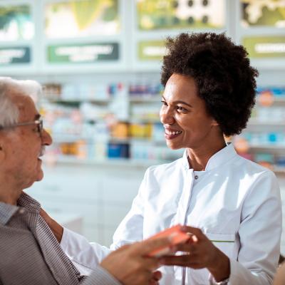 A female pharmacist helping senior customers.