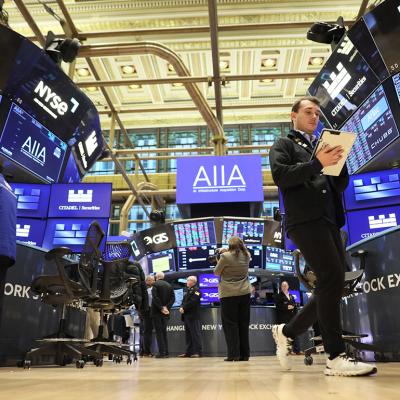 Traders work on the floor of the New York Stock Exchange during morning trading on November 19, 2025 in New York City.