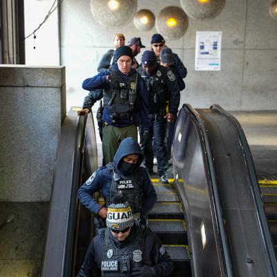 Federal and local law enforcement teams patrol the Farragut West Metro station on November 27, 2025 in Washington, DC.