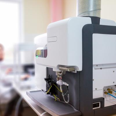 A focus on a microwave plasma atomic emission spectrometer (MPAES) a scientist is working with in a laboratory.