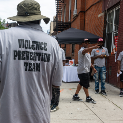 Members of a violence prevention team gather near a hookah lounge in New York City. 