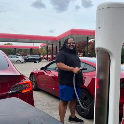 Phillip Stafford charges his car with a Tesla charger at his preferred gas station, Sheetz.