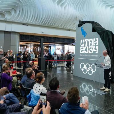 A crowd watches as organizers reveal a new name and logo — Utah 2034 — at Salt Lake City International Airport, as they count down les than 3,000 days until the Olympic Winter Games return to Utah.    