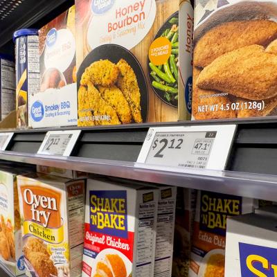 Digital price tags on display for the seasoning mix shelf in a grocery.