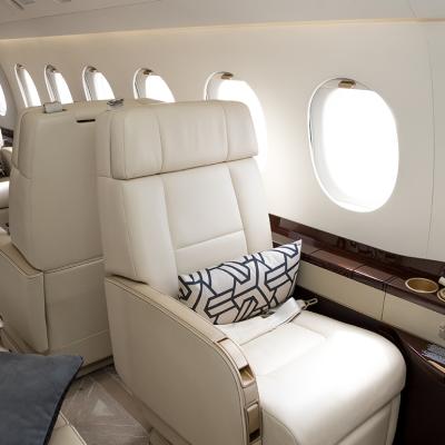 Cream-colored leather seats in a private business jet.