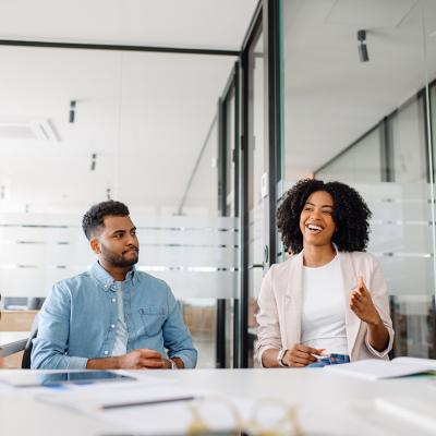 A diverse business team in a meeting room engaged in discussion.