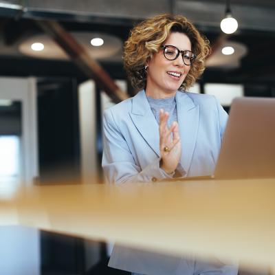 A businesswoman on a video call in an office.