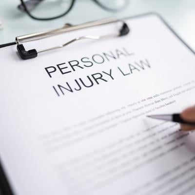 Personal Injury Law document on a clipboard.