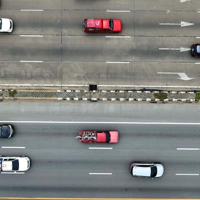 Aerial view of moving vehicles on a multi-lane highway.