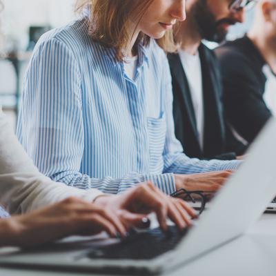 A row of employees working in an office.