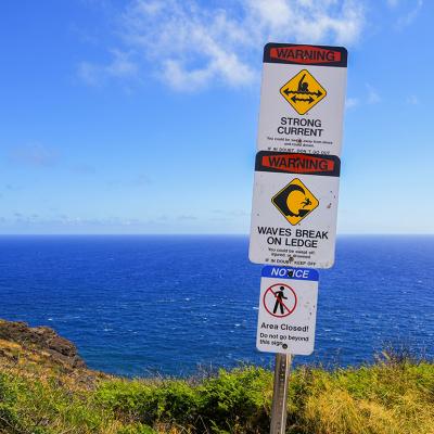 Warning signs along the Makapu'u Trail on Oahu island in Hawai'i.