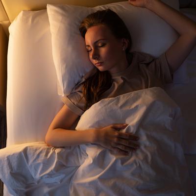 A young woman sleeping on her back.
