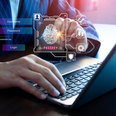 Person using a laptop illustrated with graphics of digital user login interface.
