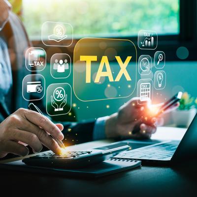 A businessman calculating taxes illustrated with tax deduction software graphics.