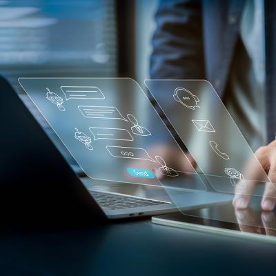 Businessman using laptop illustrated with AI software technology graphics.