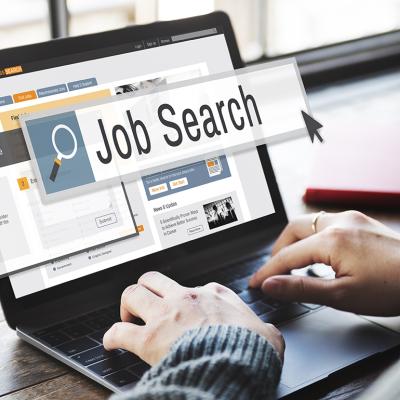 Job search display and graphics coming out of a person using a laptop.