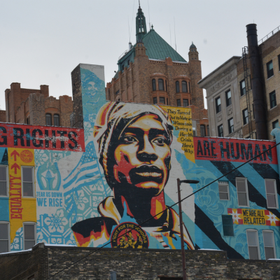 A Shepard Fairey-designed voting-rights mural rises over downtown Milwaukee, where voters and election officials remain under scrutiny for their election practices.