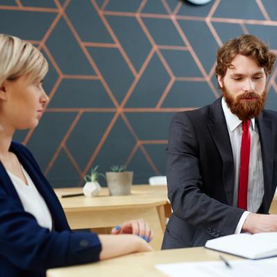 A female employee listening to her colleague at work.