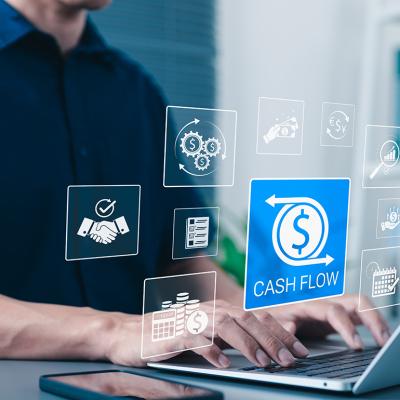 Businessman using laptop illustrated with cash flow application graphics.