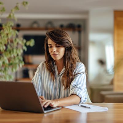 A woman using a laptop working from home.