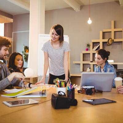 A graphic design team in a meeting room working on a project.