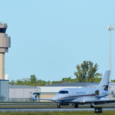 A private Charter Cessna Citation Latitude Jet on a runway in Sarasota-Bradenton International Airport.